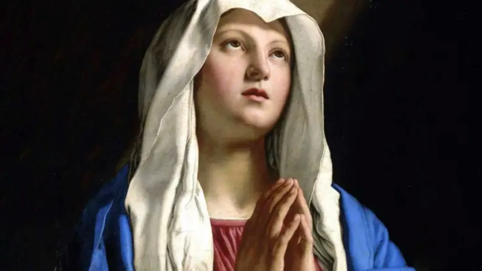 Classical painting of the Virgin Mary with hands in prayer, wearing a white veil and blue robe, illuminated by soft divine light.