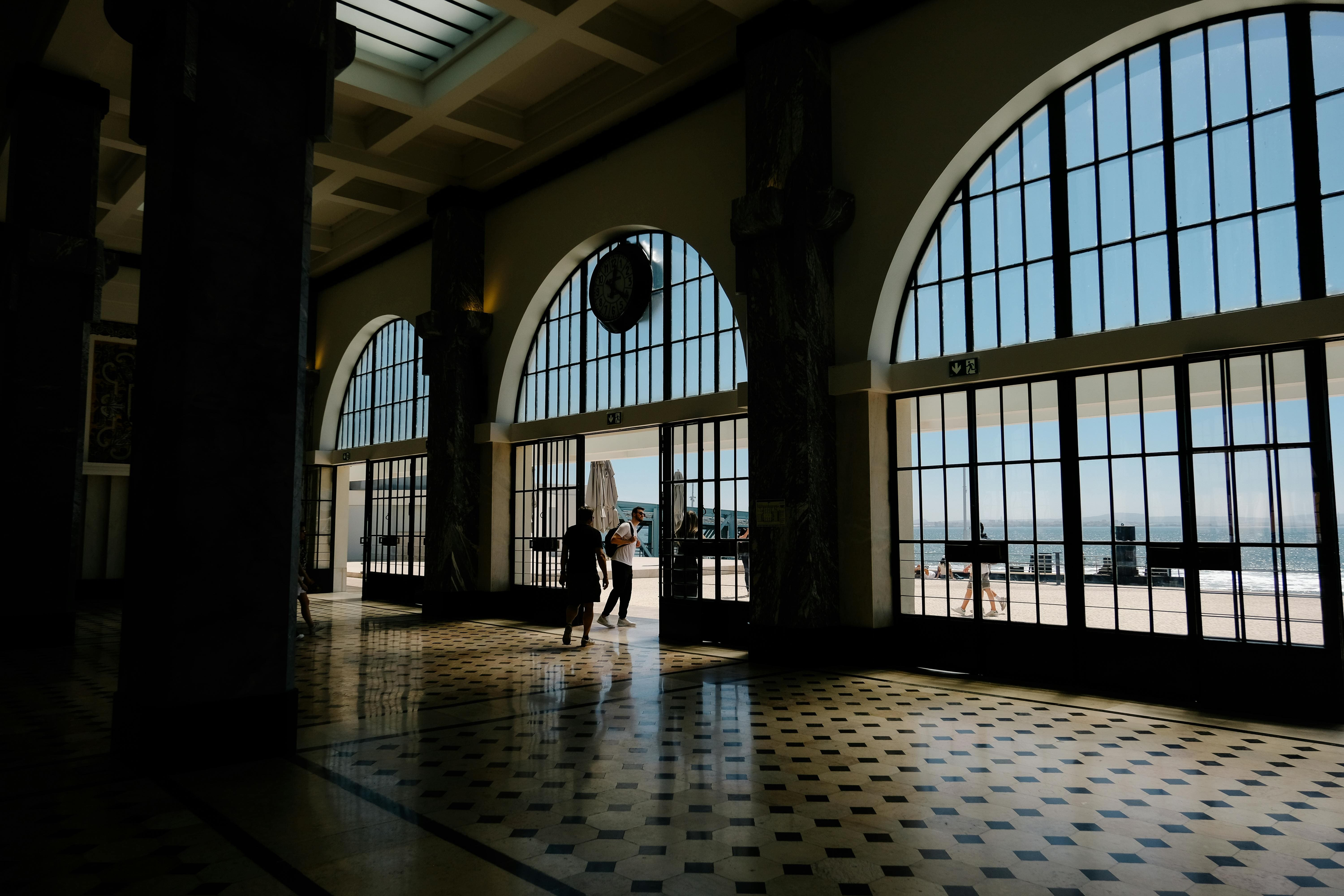 Sunlight entering through the arched windows of Sul e Sueste Station, with a view of the Tagus River