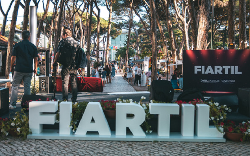 FIARTIL sign at the entrance of the fair with people exploring the artisan market