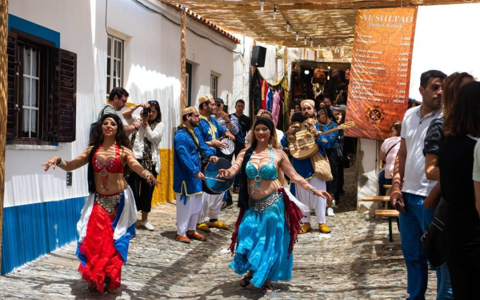 Belly dancers and musicians parade through the streets during the Islamic Festival of Mértola