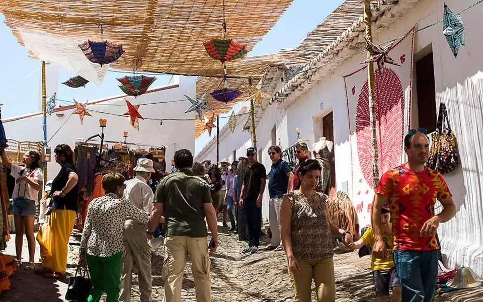 Visitors walk through the open-air Arab market during the Islamic Festival of Mértola