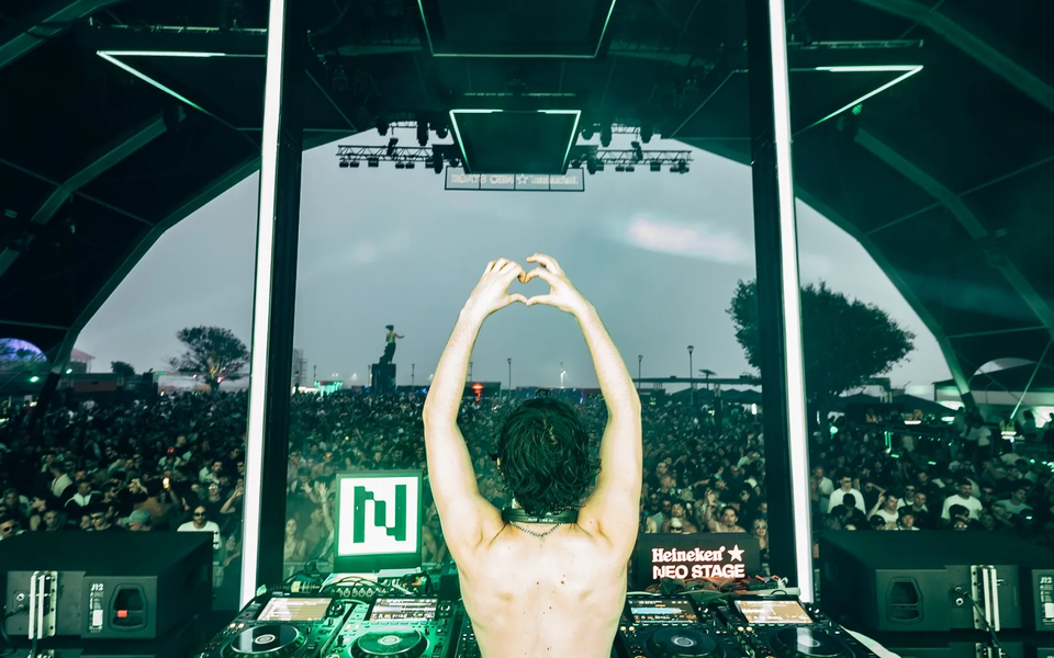 DJ performing at the Heineken Stage during NOS Alive Festival in Portugal, with a large crowd and vibrant lights