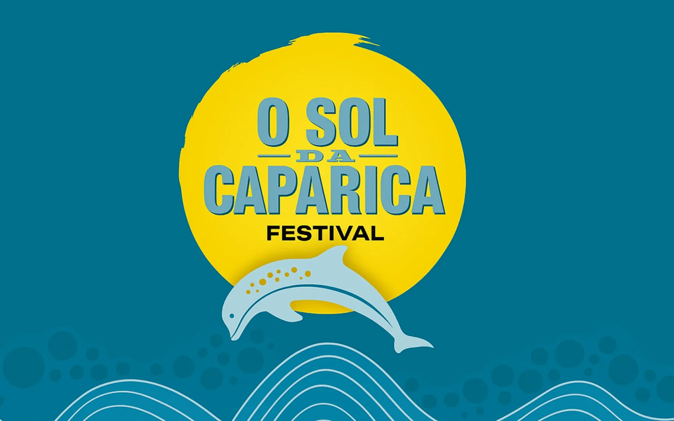 Logo of O Sol da Caparica Festival in Portugal, with a yellow sun, blue dolphin, and ocean waves design